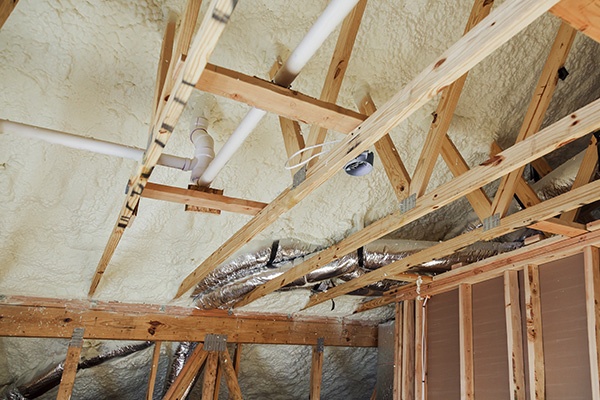Spray foam insulation in an attic.