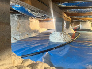 Conditioned crawl space featuring vapor barrier and 3.5" of open cell spray foam applied to foundation walls.