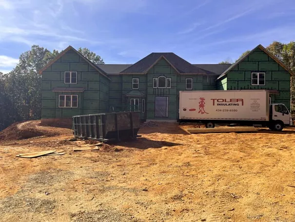 Toler Insulating truck parked outside of new home construction