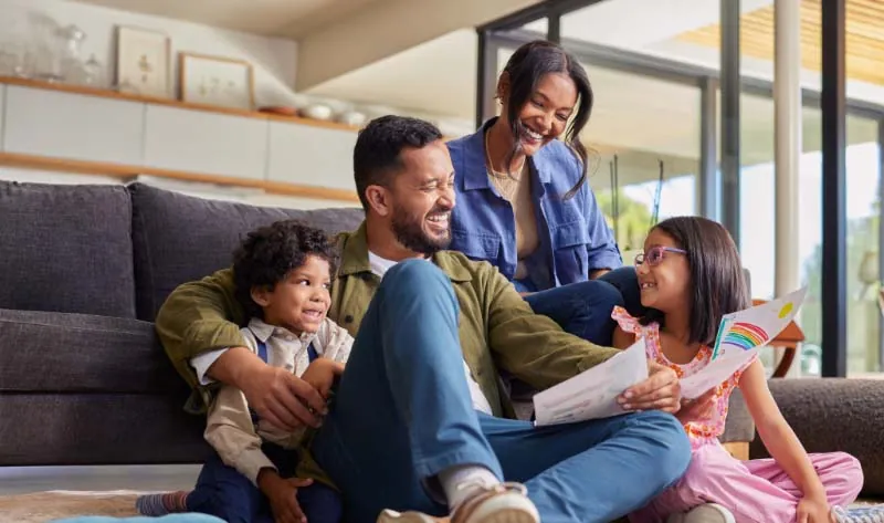 Smiling family relaxing together in a comfortable, well-ventilated home with balanced indoor temperature.
