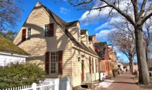 Traditional Virginia-style home with gable roof and attic windows representing regional housing and climate context.