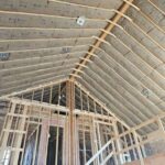 Vaulted ceiling with kraft-faced fiberglass insulation installed by Toler Insulating.
