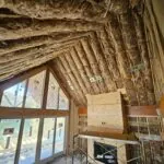 Fiberglass batt insulation installed in wall and ceiling cavities by Toler Insulating during residential construction in Virginia.