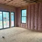 Fiberglass batt insulation installed in wall and ceiling cavities by Toler Insulating during residential construction in Virginia.