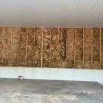 Garage under construction with fiberglass batt insulation installed by Toler Insulating for enhanced energy efficiency.