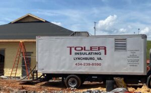 Toler Insulating service truck parked at a residential construction site during spray foam insulation installation in Lynchburg, Virginia.