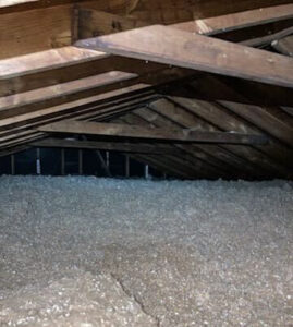 Attic floor filled with stabilized cellulose insulation between exposed roof rafters, Lynchburg, VA.