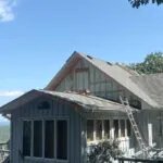 Toler Insulating closed cell spray foam applied from the exterior into open gable wall cavities of a hillside home during a renovation in Lynchburg, VA.